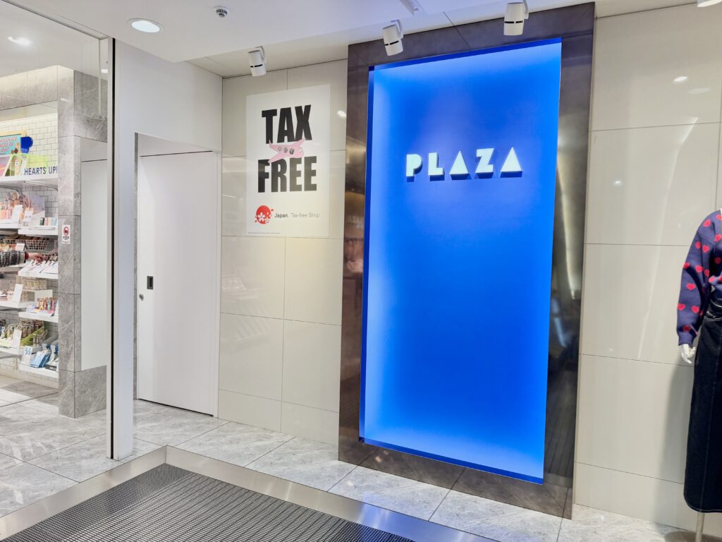 Tax-free shopping sign inside a Japanese shopping mall near stationery and sticker stores